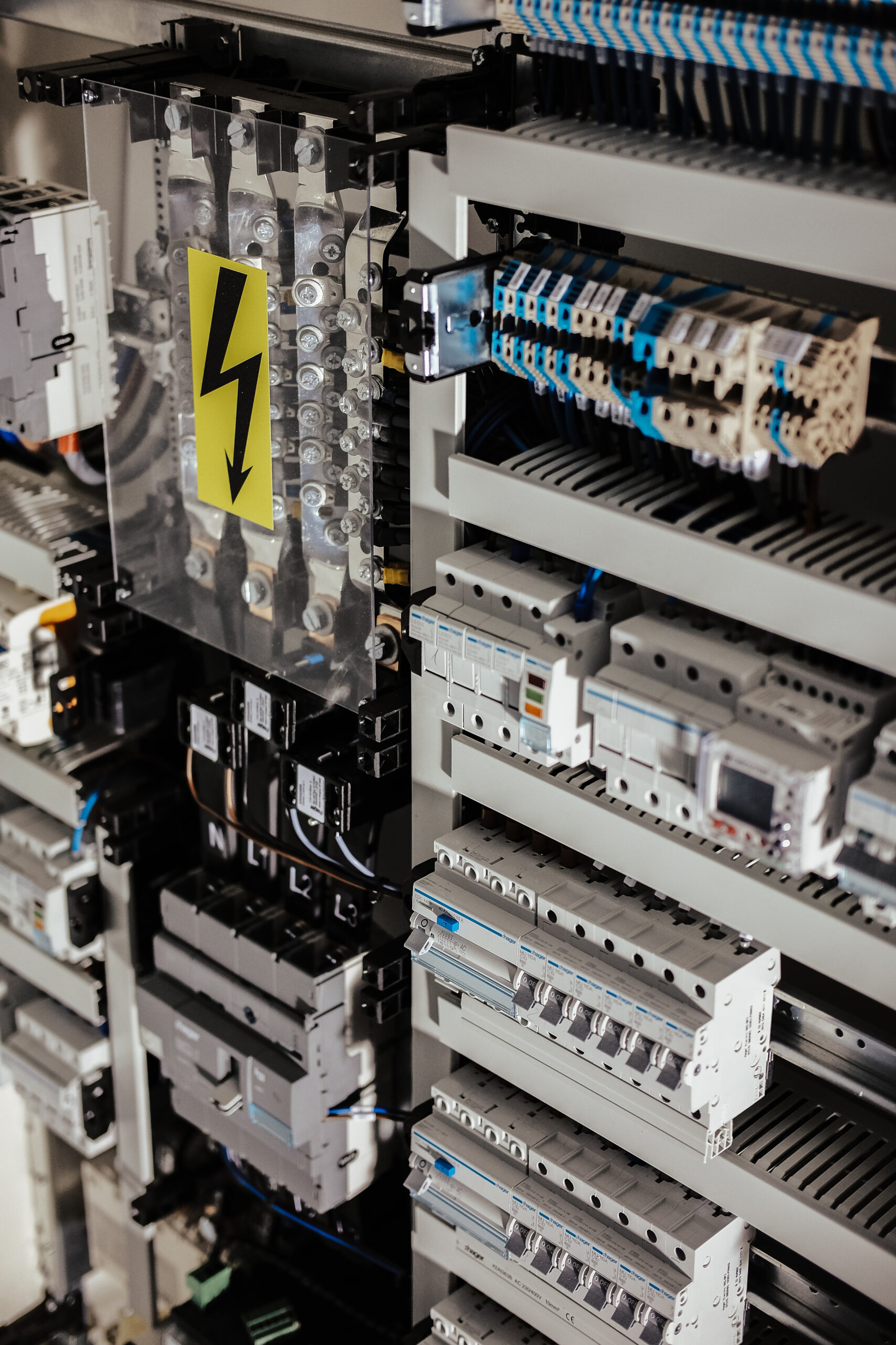 vertical shot of cords and wiring with a warning shock sign